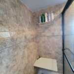 A bathroom with tiled walls and a shower stall, perfect for a bathroom remodel.
