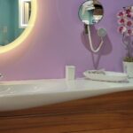 A bathroom with purple walls and a sink, perfect for a bathroom remodel.