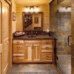 A log cabin bathroom with a glass shower.