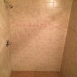 A tiled shower with a tiled floor, perfect for a bathroom renovation.