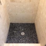 A bathroom with a black and white tiled floor.