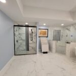 A bathroom with marble floors and a walk-in shower, perfect for a luxurious bathroom remodel.