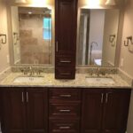 A bathroom with two sinks and a mirror for a bathroom remodel.