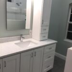 A bathroom with white cabinets and counter tops for a bathroom remodel project.