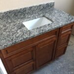 A bathroom vanity with granite countertops is the perfect addition to any bathroom remodel.