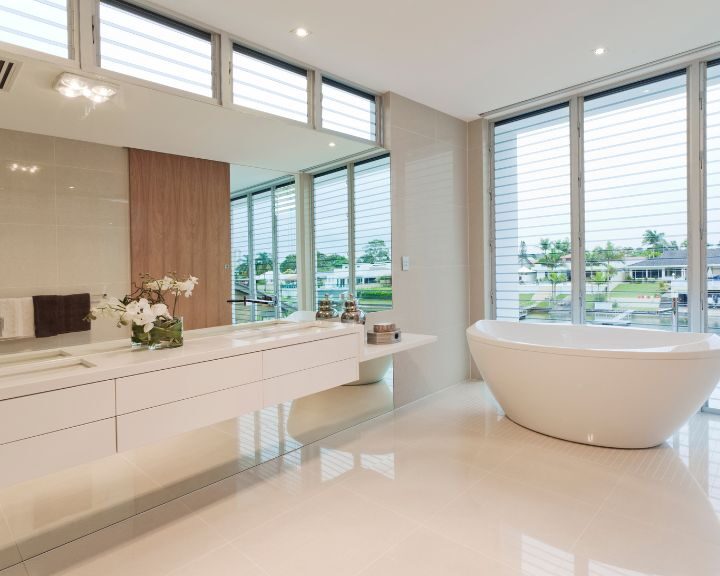 A modern bathroom with a large tub and large windows, perfect for a relaxing soak.