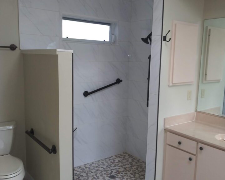 A bathroom with tiling, a toilet, and sink.
