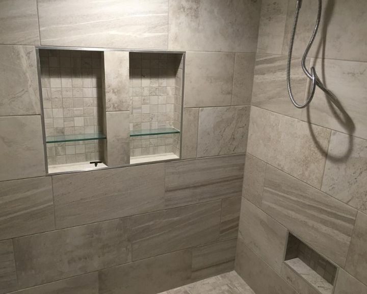 A tiled shower with a glass door.