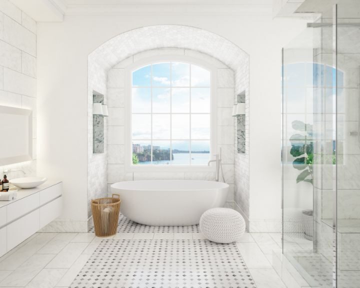 A white bathroom with a bathtub and a window perfect for relaxation.