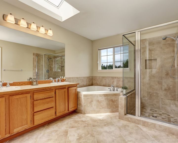 A bathroom with a skylight and tile floors for a shower.