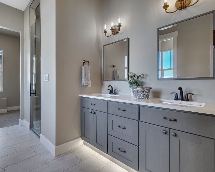 A modern bathroom with double sinks and a large mirror.