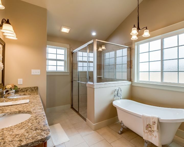 A bathroom with a bathtub, sink and tiling, perfect for a relaxing soak or shower. Ideal for a quick bathroom remodel.