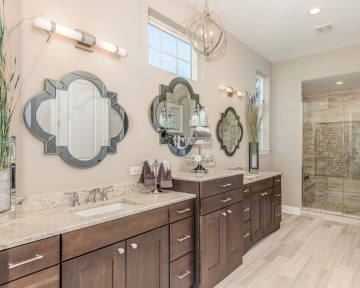 A bathroom with two sinks and a large mirror for a bathroom remodel.