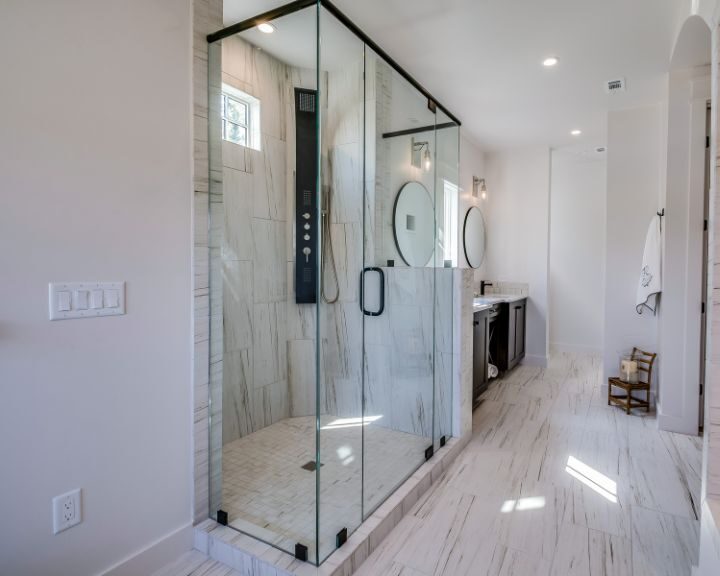 A white bathroom with a glass shower.