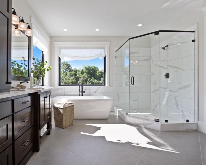 A modern bathroom with a large walk-in shower and stylish tiling.