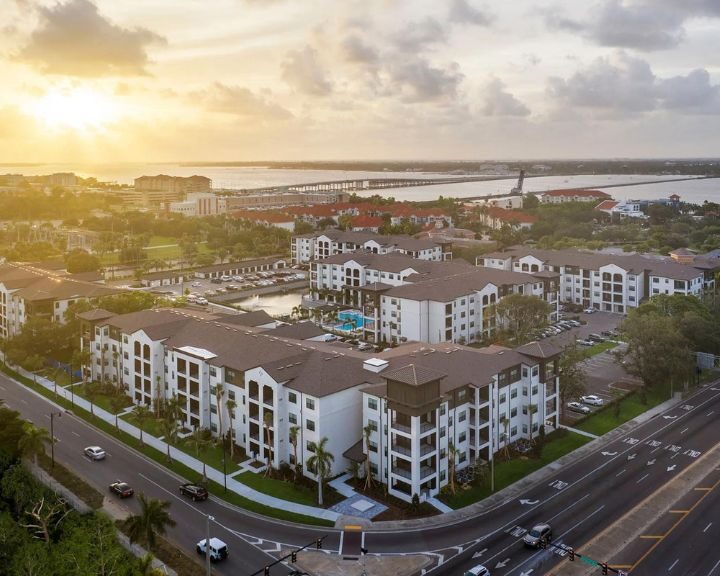 An aerial view of an apartment complex at sunset with a bathtub.